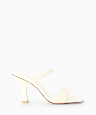 Ivory leather heels with a wider lower strap, an elasticated upper strap and a square toe.