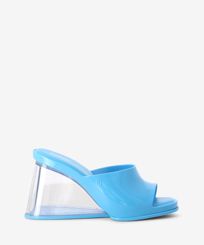 Blue wedges by Melissa with a transparent wedge heel, cushioned insole and a round toe.