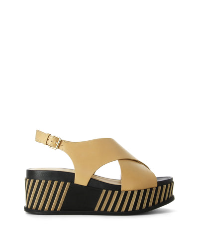 Nude leather platform sandals with a slingback buckle fastening and featuring a crossover upper, chunky striped platform sole and an open round toe by Elvio Zanon.
