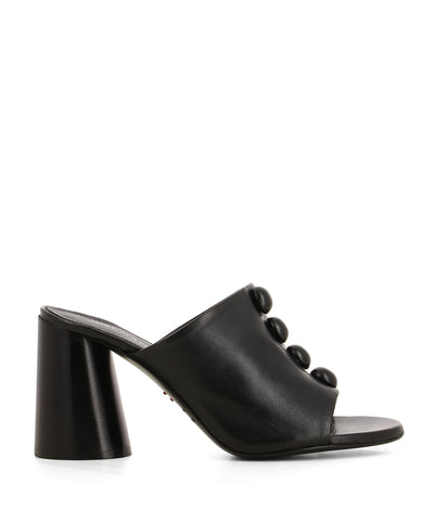 An Italian made black leather mule featuring circular domes on the upper, a cylindrical block heel, and a round toe - handmade in Italy by Halmanera. This style runs true to size.