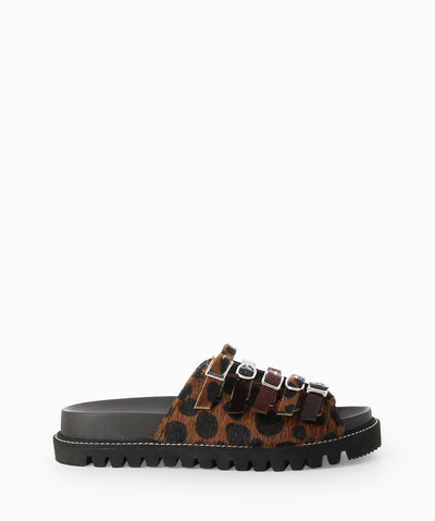 Leopard print ponyhair slides with multiple buckled straps, a moulded footbed, tread sole and a round toe.