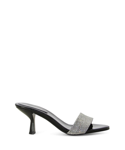 Sparkly silver and black leather mules featuring a single diamanté embossed strap across the toe, hourglass heel, and a square toe by Jeffrey Campbell. 