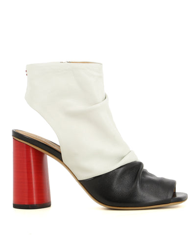 A contrasting black and white leather peep toe heel by Halmanera. The 'Gloria01' has zipper fastening and features a slouched upper, open heel, a red block heel and a square toe.