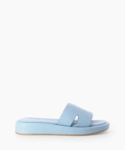 Blue leather platform slides with notched strap, cushioned insole and a soft square toe.