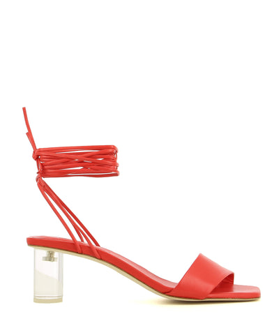 A red leather strappy sandal by Beau Coops. The 'Kim' features a transparent block heel, a wrap around ankle strap and a square toe. 