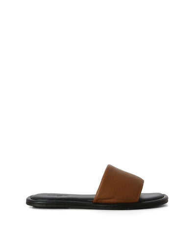 Tan leather slip on slides with a thick strap, black sole and a round toe by Urge.