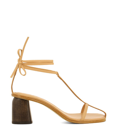 Timeless strappy nude leather heels that have tie up ankle straps and a feature a t-bar style upper, a brown block heel and an open square toe by Beau Coops.