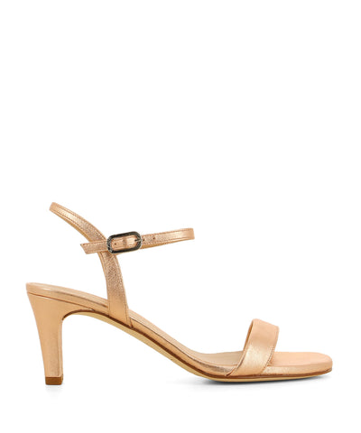 A metallic ballet pink heeled sandal featuring a soft square toe, an ankle strap fastening and a 7.5cm block heel. Made by Unisa. 