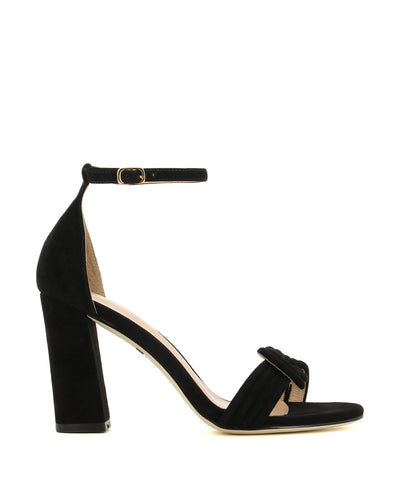 A high heeled sandal by Robert Robert. The 'Molly' has an ankle strap with a buckle fastening, and features a plaited rope like upper and a round toe. 