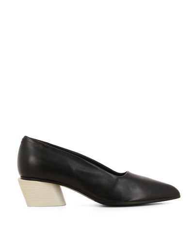 An Italian made timeless black leather pump that features a square topline, a contrasting white block heel, and a pointed toe by Halmanera. 
