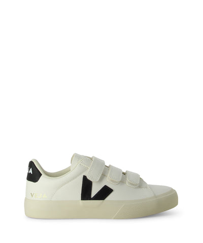 Flat white leather sneakers with three velcro straps and a black V logo on the side.