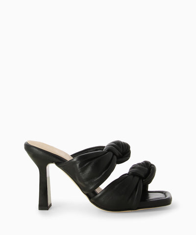 Black leather heels with two knotted leather straps, a slender heel and a soft square toe.