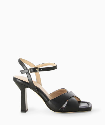 Black leather heels with a crossover upper, slender heel and an open square toe.