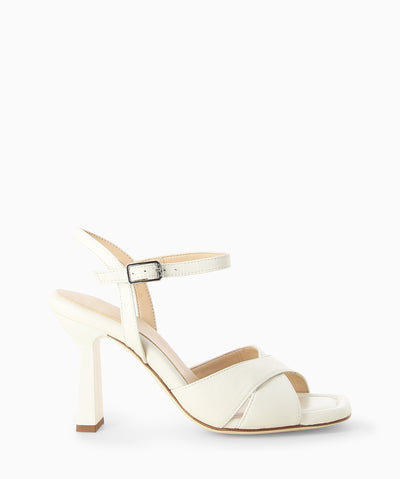 Ivory leather heels with a crossover upper, slender heel and an open square toe.