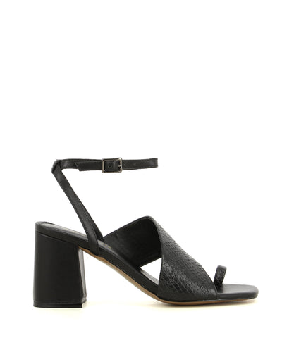 A black leather heel that has a buckle fastening and features a snake printed leather strap over the arch, a clear PVC panel, a toe loop, a 8.5cm block heel, and a square toe by 2 Baia Vista. This style runs true to size.