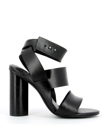 A thick strap black leather sandal by Senso. The 'Xander' has a prong fastening and features a cylindrical block heel and a round toe.