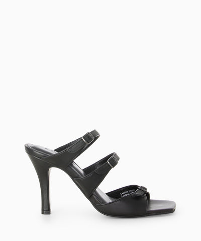 Black leather heels with three buckled straps, a high heel and a soft square toe.