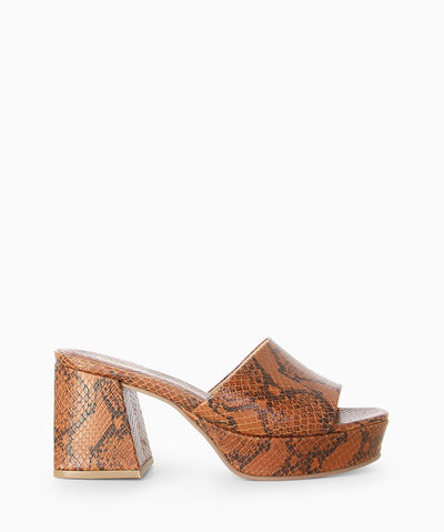 Brown leather platform mules with snakeskin embossed upper, block heel and a round toe.
